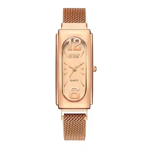 Close-up of rose gold rectangular quartz watch with mesh strap and large numerals