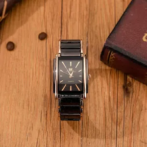 Elegant men's rectangular quartz watch with rose gold trim on a wooden background