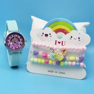 Close-up of kids' green watch with rainbow dial and three colorful beaded bracelets