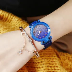 Blue starry sky watch with magnetic band and gold star bracelet on a knit sleeve