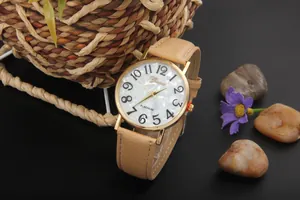 Detail of Geneva quartz watch featuring a pearl dial and beige leather strap on a rustic background