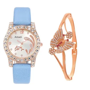 Close-up of luxury rhinestone watch with blue strap and sparkling butterfly bracelet