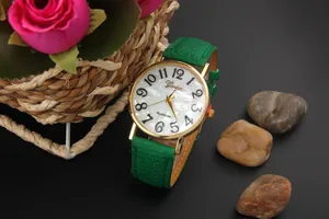 Detail of Geneva watch with green leather strap and white mother-of-pearl dial