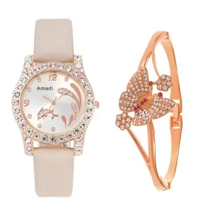 Detail view of quartz watch with beige leather strap and rhinestone butterfly bracelet