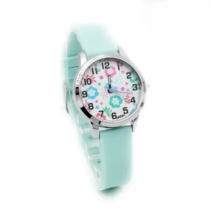 Detail view of mint green silicone strap and colorful floral dial on kids quartz watch