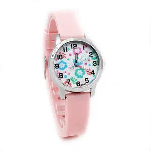 Macro detail of kids pink silicone watch showing flower dial and silver case engraving