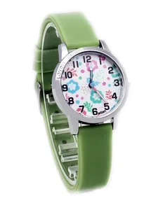 Macro view of green silicone strap and cute floral pattern dial on kids watch