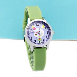 Close-up of green silicone strap child watch with white rabbit and purple dial detail