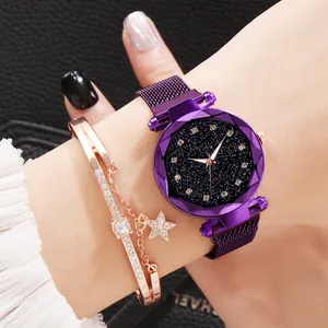 Close-up of starry dial watch with purple mesh band and rose gold star charm bracelet