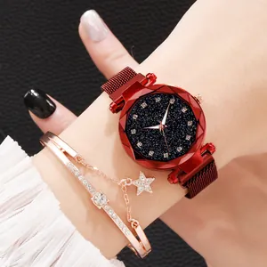 Detail of starry dial watch with red magnetic strap and matching star bracelet on wrist