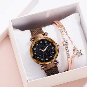 Close-up of star-themed rose gold mesh watch and sparkling star charm bracelet in gift box