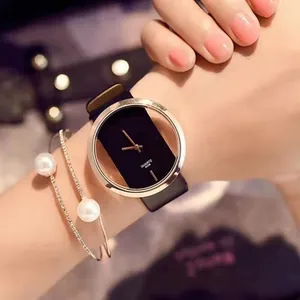 Golden quartz watch with hollow black dial and leather strap paired with pearl bracelets