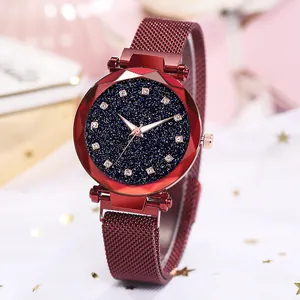 Close-up of red Milanese loop watch with starry blue dial and rhinestone indices