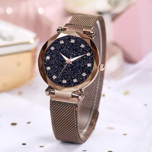 Close-up of starry sky dial watch with rose gold milanese mesh band and crystal markers