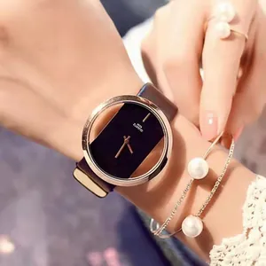 Close-up of minimalist gold hollow quartz watch with black dial and brown leather strap