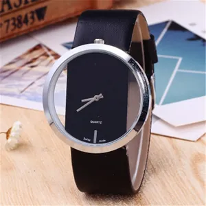 Detail of minimalist quartz watch with floating dial and black leather strap on wooden desk