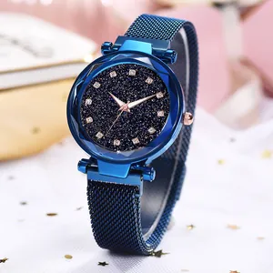 Macro detail of dark blue starry dial with sparkling crystals and Milanese mesh watch strap