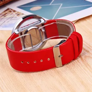 Stylish women's quartz watch with red leather strap and silver buckle on wood background