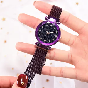 Detail of starry dial watch with faceted crystal and purple Milanese mesh band