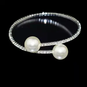 Detailed view of silver open bracelet with dual pearls and sparkling zircons