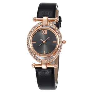 Close-up of rose gold watch case with crystal bezel and black leather strap detail