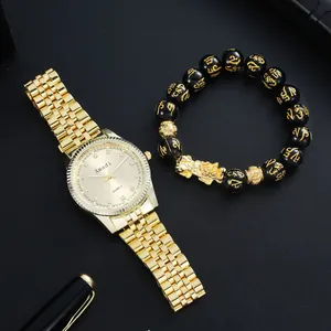 Close-up of luxury gold men's watch set with black beaded Pixiu charm bracelet