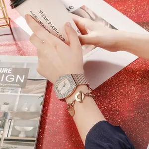 Close-up of luxury rose gold rhinestone watch and heart bracelet on a female wrist