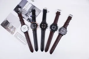 Flat lay of multiple stylish business men watches with leather straps and round faces