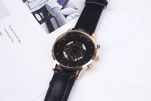 Close-up of Geneva rose gold business watch with black dial and leather strap