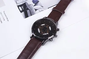 Detail of Geneva business watch with brown leather strap and black decorative dial
