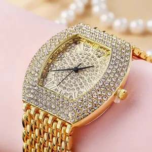 Close-up of luxury gold quartz watch featuring a full diamond dial and Roman numerals
