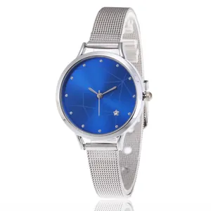 Detail of silver mesh band watch featuring a blue sunray dial with star accent