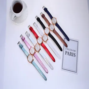 Flat lay of eight colorful faux snakeskin strap quartz watches for women with rose gold cases