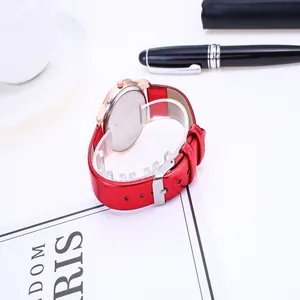 Detail of red snake pattern leather strap and rose gold case of women quartz watch