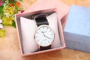 Detail of Geneva quartz watch with black leather strap in pink gift packaging