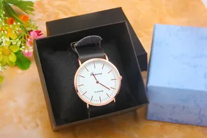 Close-up of Geneva rose gold watch with black leather strap in elegant gift packaging