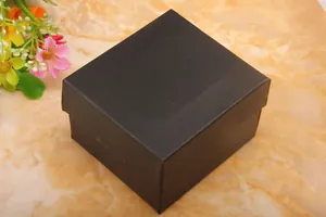 Detail of a square black textured watch gift box with a minimalist lid design