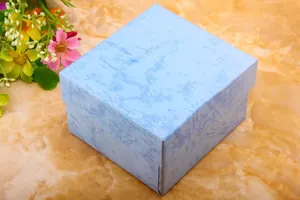 Macro shot of sky blue marble pattern square paper gift box with lid and base design