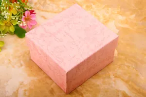 Detailed close-up of pink marble pattern gift box with lid on a stone surface
