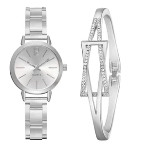 Close-up of polished silver quartz watch and matching geometric star bracelet set
