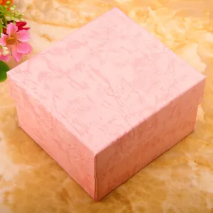 Pink marble texture square watch gift box with lid and elegant floral background