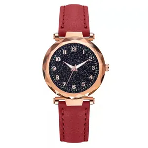 Macro view of starry sky watch face with rose gold metal case and red leather strap