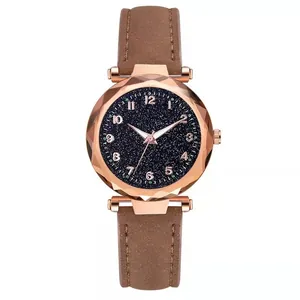 Detail of starry blue dial quartz watch with brown matte strap and rose gold case