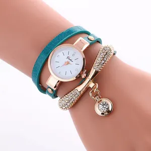Detailed view of turquoise multi-layer leather strap watch with gold rhinestone charms