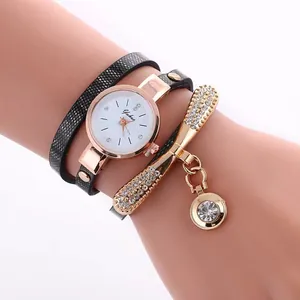 Detail of multi-layer wrap watch with snake pattern strap and sparkling bow rhinestones