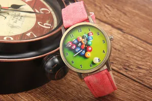 Detail of vintage bronze quartz watch with billiards dial on pink denim strap