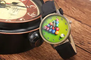 Detail of creative billiard theme watch with green dial and bronze case on wooden table