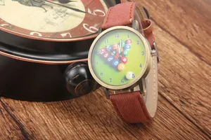 Detail of vintage bronze watch with green billiard dial on rustic wooden table