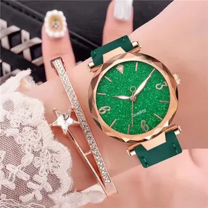 Close-up of women's quartz watch with green glitter dial and matching star bracelet
