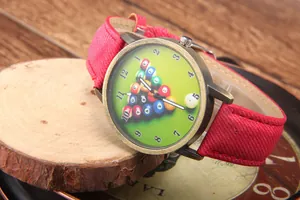 Macro shot of bronze quartz watch with billiards theme dial and red fabric strap